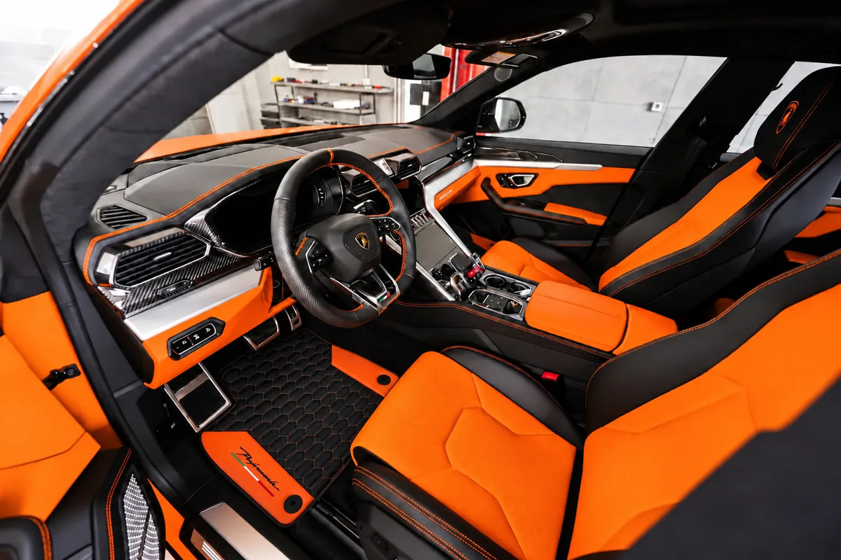 Black Floor Mats for Lamborghini Urus with Orange Leather inside the vehicle
